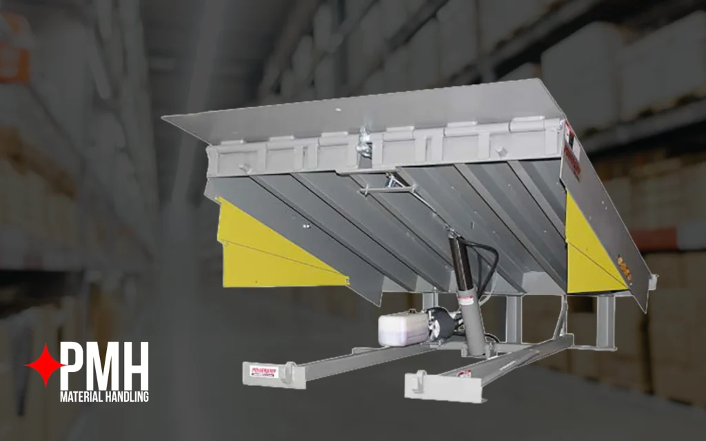 Hydraulic dock leveler with a steel platform and yellow side panels displayed in a warehouse setting, used for bridging the gap between loading docks and trailers for safe material handling operations.
