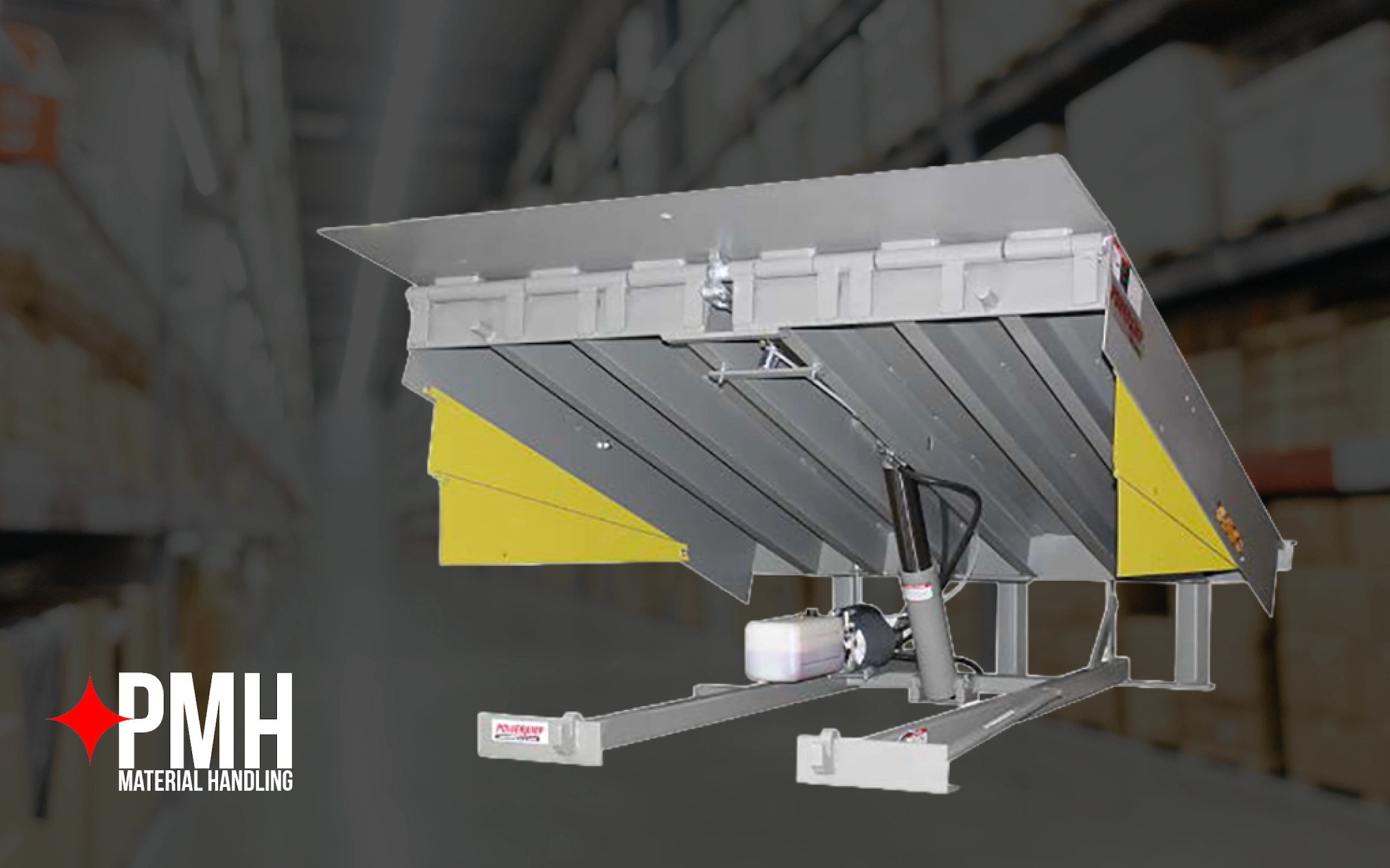 Hydraulic dock leveler with a steel platform and yellow side panels displayed in a warehouse setting, used for bridging the gap between loading docks and trailers for safe material handling operations.